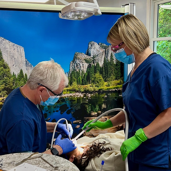 Andrew Kuhlberg With Assistant And Patient Performing Exam